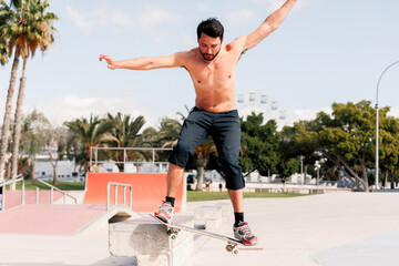 Boy doing skateboard trick on rail