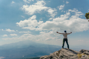 man standing on a mountain top