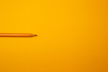 Orange pencil on a bright background