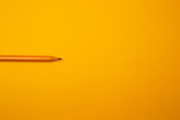 Orange pencil on a bright background