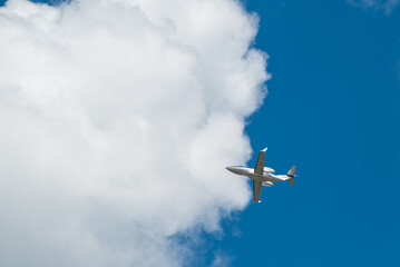 Fototapeta na wymiar Jet Private Airplane With Sky Background Clouds Taking Off