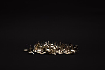Metal push pins on background