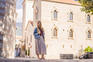 Fototapeta premium Young woman tourist in the old town of Budva. Travel to Montenegro concept