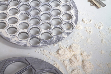 Metal dumpling maker for making homemade dumplings, varenik, ravioli sprinkled with flour
