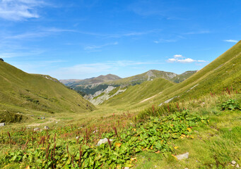 Beautiful wild mountainous valley with volcanic mountains under a blue sky during the summer