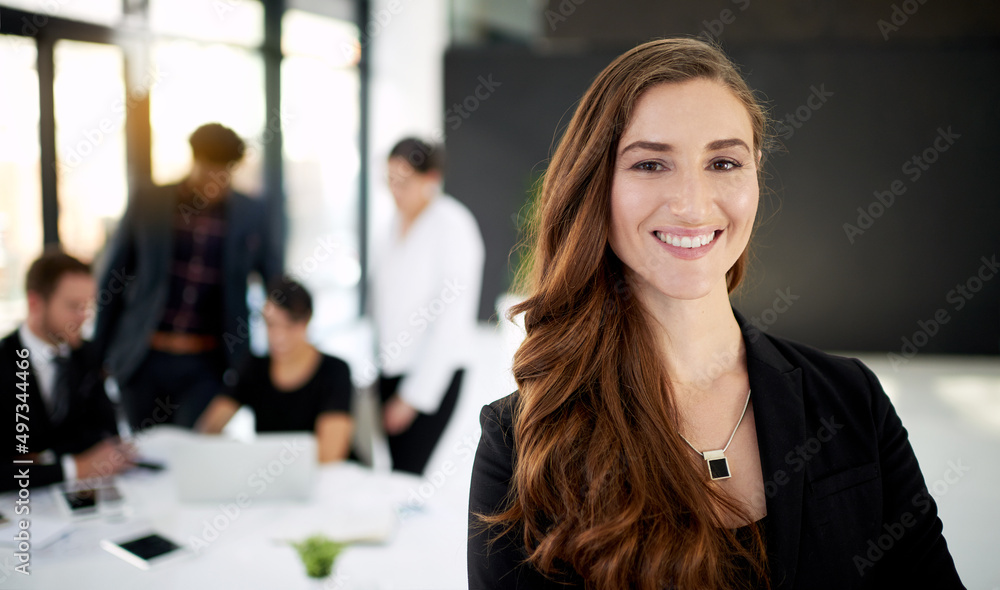 Poster my team will get it done. portrait of a businesswoman standing in a boardroom meeting with colleague