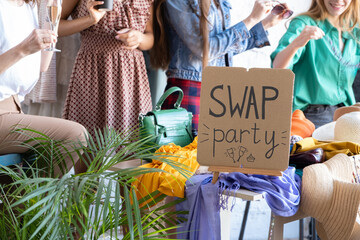 Young women at swap party. Casual clothes, shoes, hats, bags, jewellery. Idea of exchange your old...