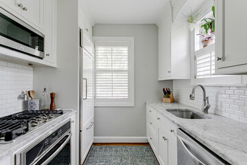 White grey minimal kitchen subway tile stainless steel appliance modern plantation shutters sink...
