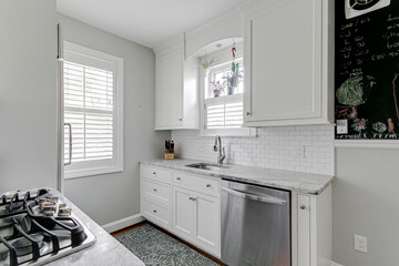 White grey minimal kitchen subway tile stainless steel appliance modern plantation shutters sink...