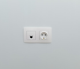 socket and connector for ftp cable in a plain wall. installed slots in the wall. concept of repair, electrical. white socket on a plain light wall