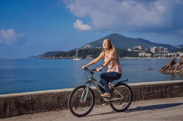 Woman tourist on a bicycle explores Budva in Montenegro. Cycling in Montenegro concept