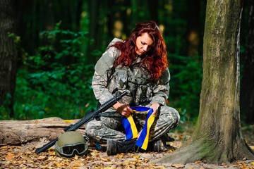 Ukranian female soldier in the forest