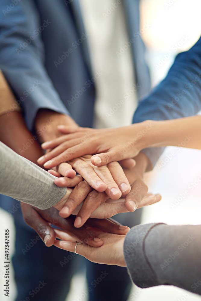 Poster Achieving success as one. Cropped shot of a group of colleagues joining their hands in unity.