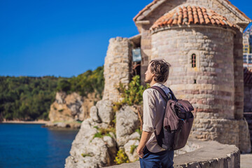 Fototapeta na wymiar Young man tourist in the old town of Budva. Travel to Montenegro concept
