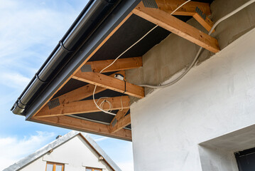 Electric socket mounted on the trusses above the garage door, electric cable in pvc pipe.