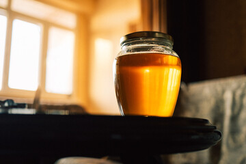 A jar of honey on the table at home. High quality photo