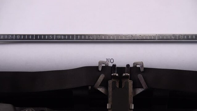 Typing phrase NO WAR ! on retro typewriter.