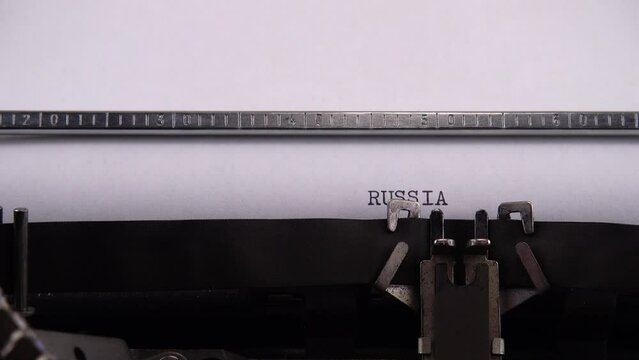 Typing phrase RUSSIA vs UKRAINE on retro typewriter.