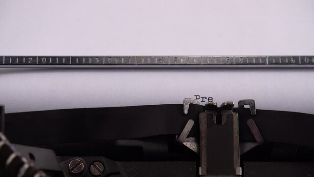 Typing phrase President of Ukraine on retro typewriter.