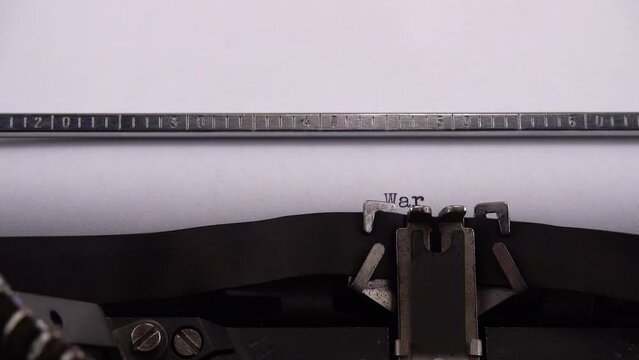 Typing phrase War in Ukraine on retro typewriter.