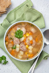 Chicken meatball soup with potato, carrot and corn