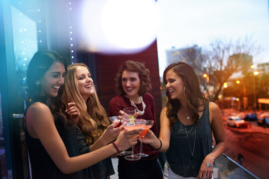 Grab Your Girls For A Great Night Out. Shot Of A Group Of Young Women Drinking Cocktails At A Party.