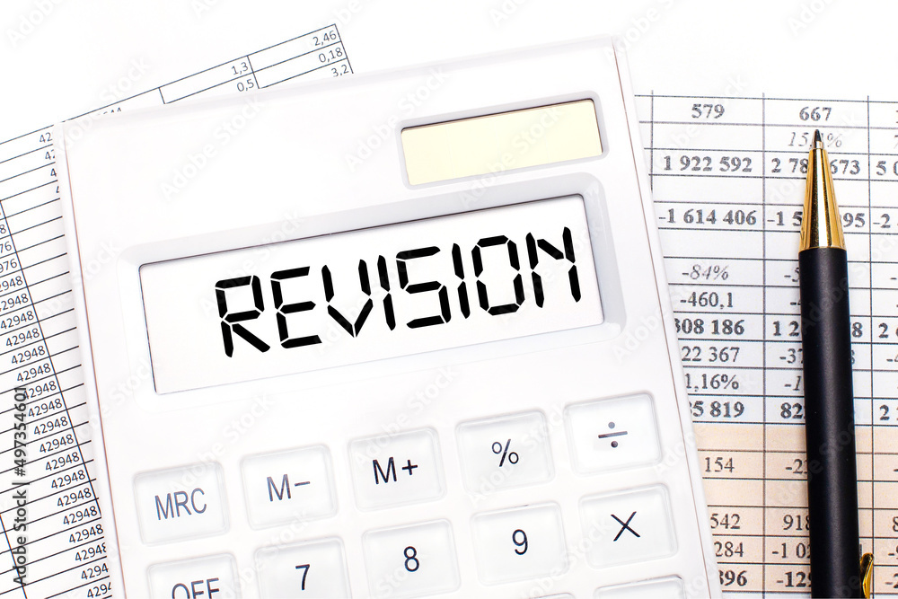 Poster on the desktop there are reports, a white calculator with the text revision on the scoreboard and a 
