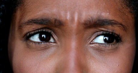 Fototapeta premium Upset African young woman macro close-up eyes, expressive angry black girl in discussion argument
