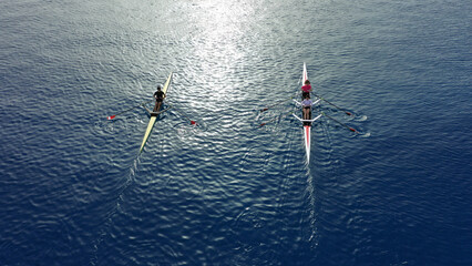 Aerial drone top down photo of woman practice competition sport canoe in deep blue sea