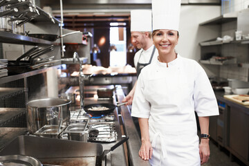 Fototapeta na wymiar Shes a master chef. Portrait of a chef in a professional kitchen.