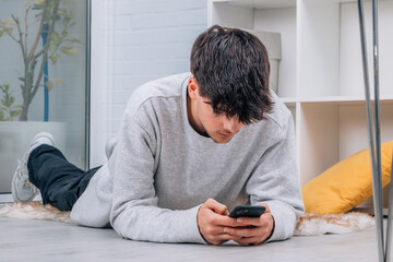 young man with mobile phone at home