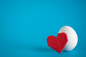 Egg love concept.  Heathy food idea. Egg and paper heart still life. Copy space
