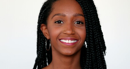 Pretty black African teen girl portrait smiling at camera on white background
