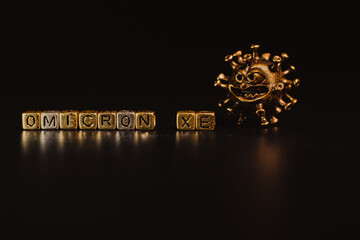 XE. A new variant of SARS-CoV-2 coronavirus. Omicron sub variant. Viral gold color on a black...