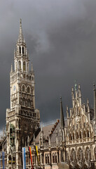 tower of the City Hall in Munich in Germany and in black sky during a thunderstorm