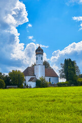 Typical Upper Bavarian chapel with storm clouds in the background, Germany.