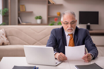 Old male employee working from home during pandemic