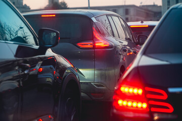 traffic. cars caught in the crowd. photo taken in the evening. people in traffic returning from work