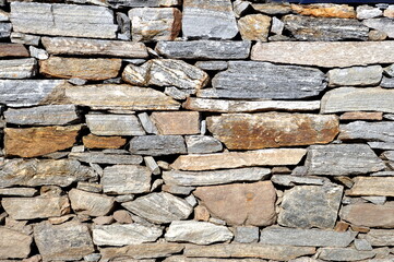 Part of the grey stone wall. Rock wall background texture.