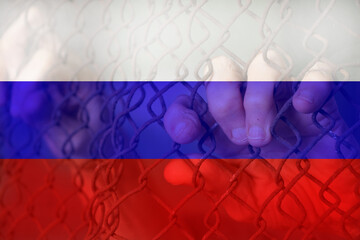 Women's hands on the fence against the background of the Russian flag, stop the war in Ukraine,...
