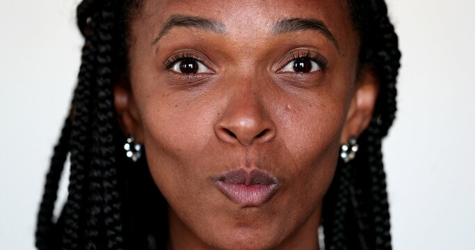 African woman grimacing making funny faces to camera. Expressive fun portrait