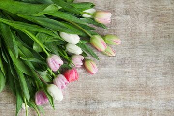 bouquet of tulips on a wooden table.