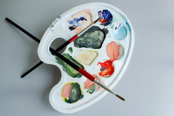 Color artist palette for drawing with to brush on white background top view