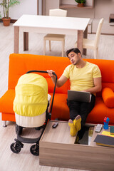 Young man looking after new born at home