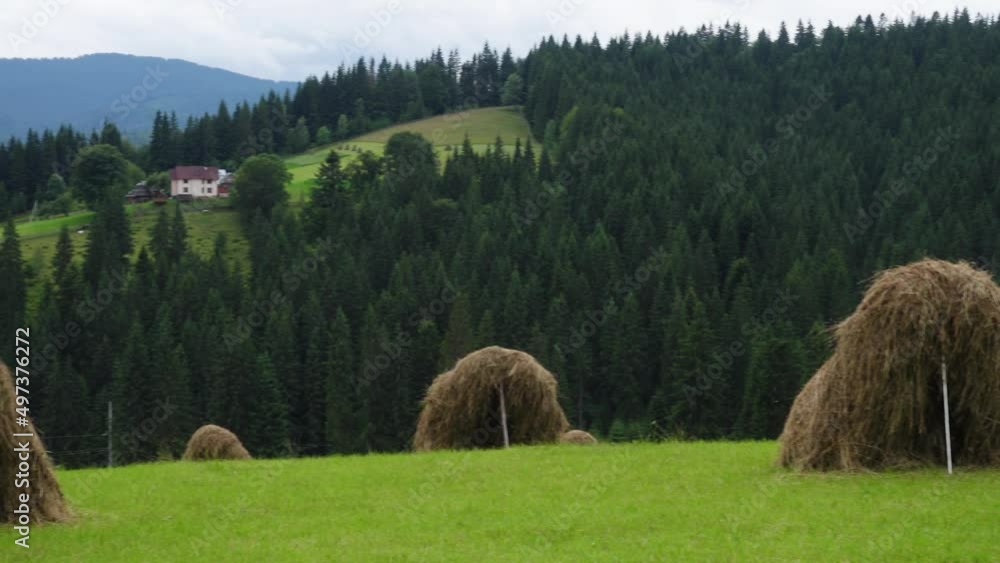 Wall mural haystacks on a mountain hill