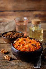 Carrot walnut raisin salad with glass of water