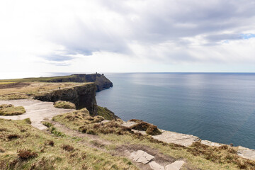 Irish cliffs on a sunny day. Cliffs of Moher tourist attraction in Ireland.