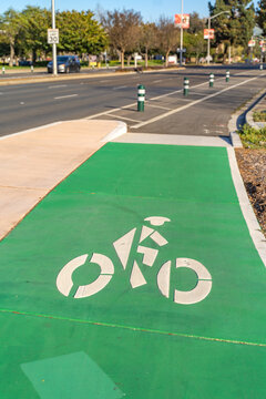 Bicycle path on a city street. A white bicycle symbol on the road. 