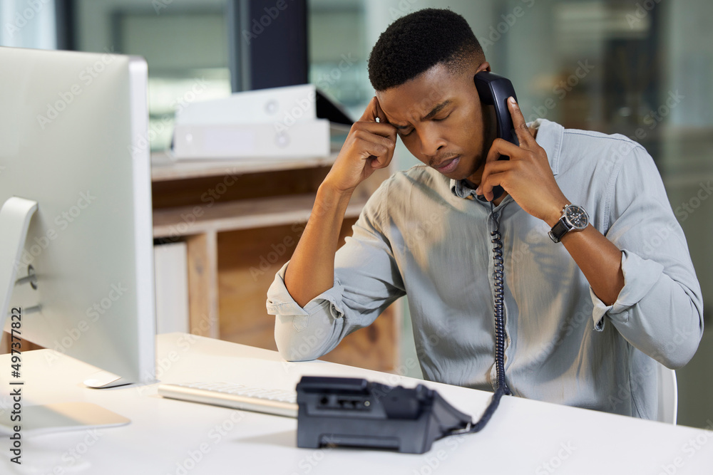 Canvas Prints Delivering bad news is a tough call to make. Shot of a young man using a phone and looking stressed in a modern office.