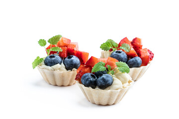 Fresh berry tartlets dessert isolated on white
